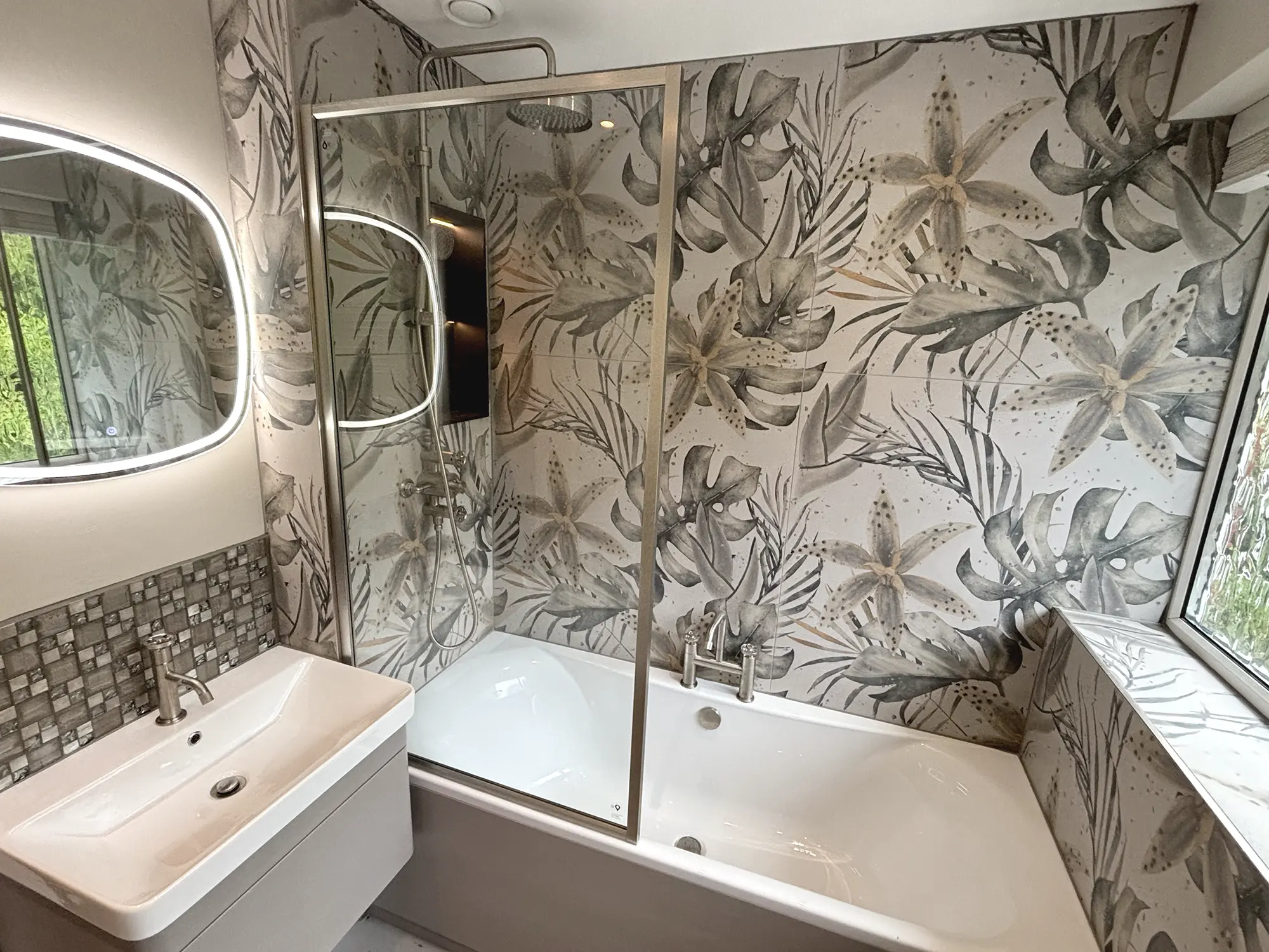 Bathroom with botanical feature wall, glass shower screen, rain shower, and LED mirror